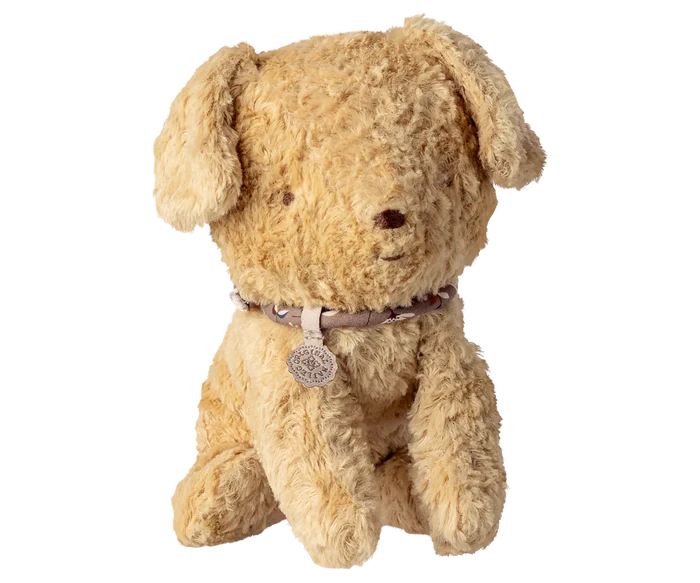 Maileg Small Puppy in Soft Sand on a white background — a soft curly-textured seated stuffed puppy in warm soft sand with floppy ears, embroidered nose, and a delicate floral collar with a Maileg charm tag