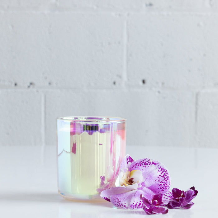 iridescent 7 oz candle with black wooden wick in citrus and floral scent