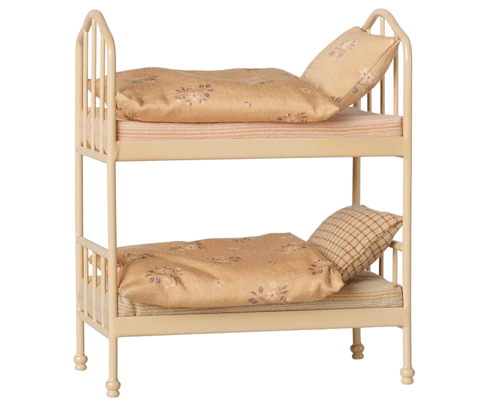 Maileg Bunk Bed in Wheat — angled three-quarter view of miniature metal bunk bed in warm wheat finish with two floral cotton mattresses, soft blankets, and pillows on each bunk