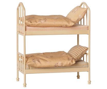 Maileg Bunk Bed in Wheat — angled three-quarter view of miniature metal bunk bed in warm wheat finish with two floral cotton mattresses, soft blankets, and pillows on each bunk
