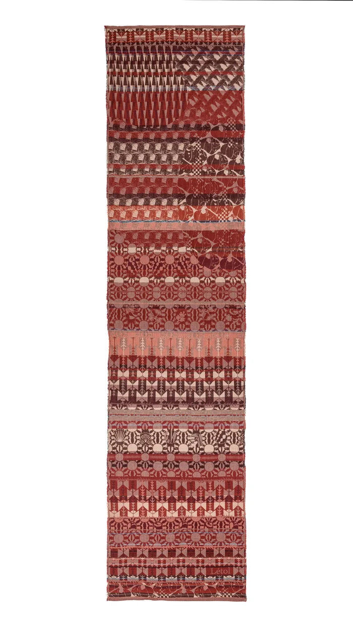 Létol Come Scarf in Burgundy & Brown, laid flat and fully extended against a white background, showing the full length of the scarf with multiple distinct horizontal bands of Jacquard-woven patterns in deep burgundy, chocolate brown, crimson, taupe, and dusty pink — including chevron and wave motifs, geometric floral rosettes, arrow and botanical repeats, and sunburst medallion rows