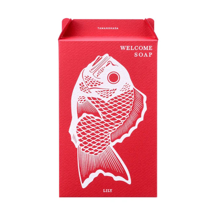 Tamanohada Lily Welcome Soap gift box — red rectangular box with white bream fish illustration and 'Welcome Soap' text, 'Lily' printed at the bottom, Tamanohada branding at the top