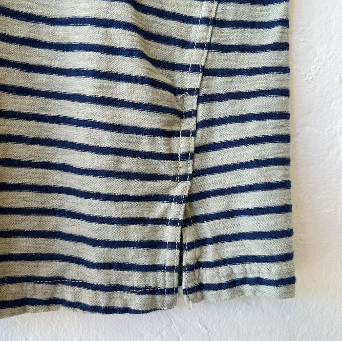 Close-up of the hem fabric with green and black stripes on a white background