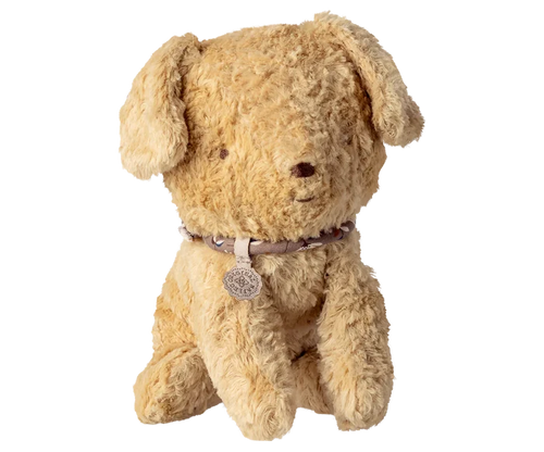 Maileg Small Puppy in Soft Sand on a white background — a soft curly-textured seated stuffed puppy in warm soft sand with floppy ears, embroidered nose, and a delicate floral collar with a Maileg charm tag
