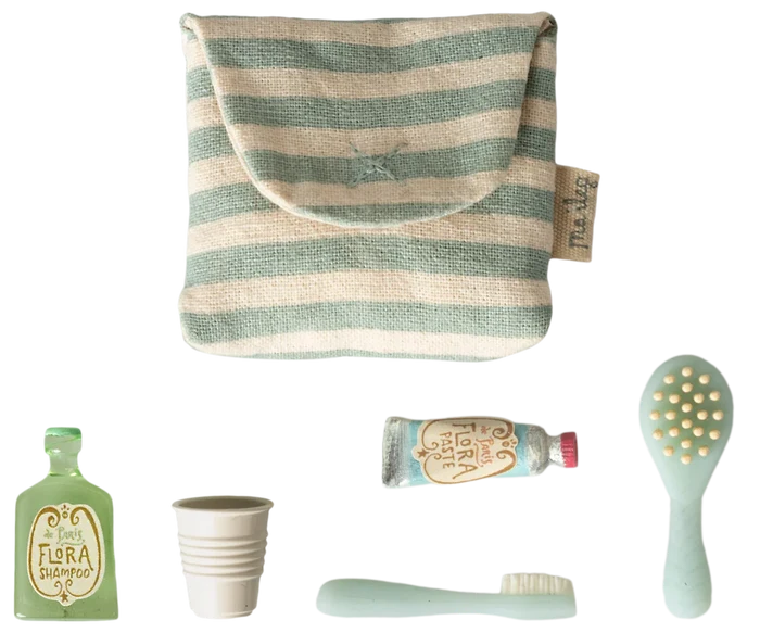 Maileg Toothbrush Set in Blue Striped Bag — flat lay of the blue and cream striped cotton toiletry bag with five miniature accessories: Flora Shampoo bottle, ribbed water cup, toothbrush, Flora Paste toothpaste tube, and hairbrush