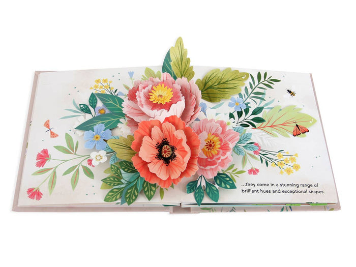 Flora: A Botanical Pop-Up Book | An open spread showing pop up flowers (poppies) and accent florals/greenery in a watercolor illustration style. Text reads "...they come in a stunning range of brilliant hues and exceptional shapes.".